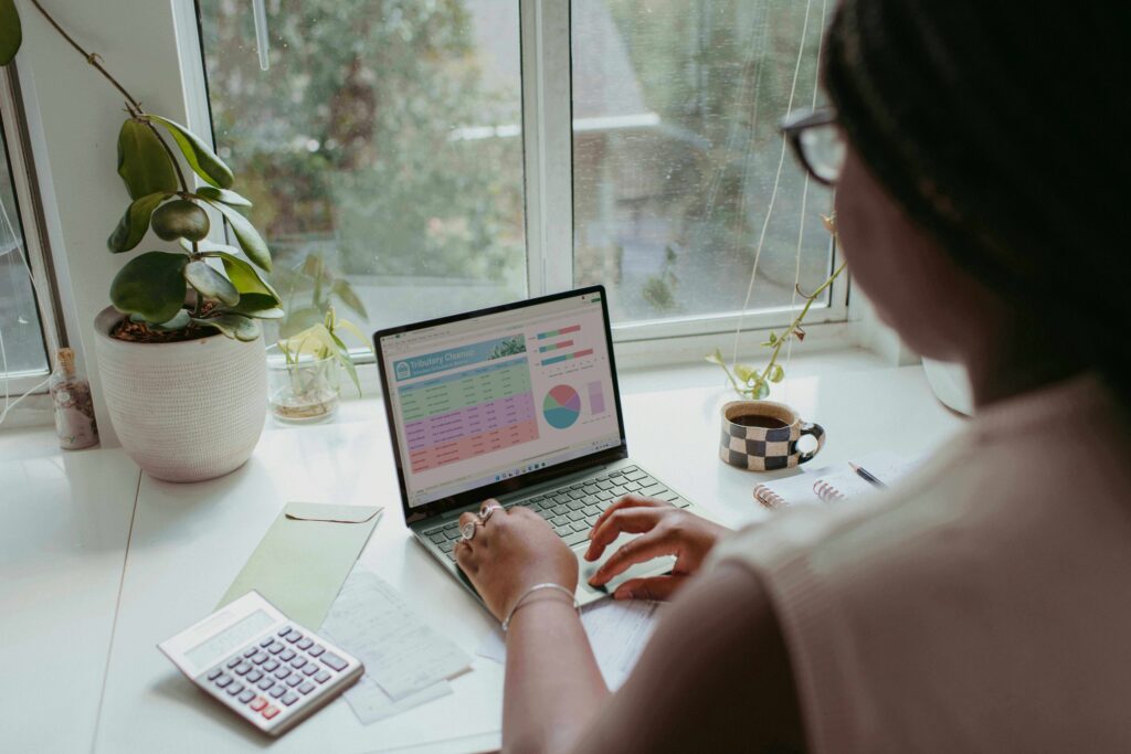  A woman reviewing her credit score on a laptop, illustrating how often Americans should check their credit report