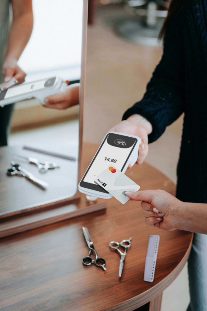 A person cutting up a credit card with scissors on a wooden table, considering the impact on their credit score